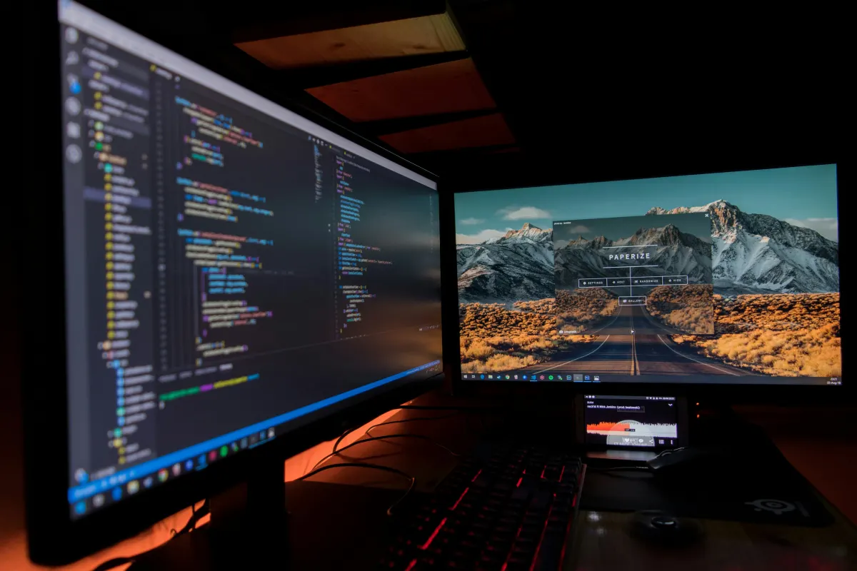 Dual monitor coding setup at night